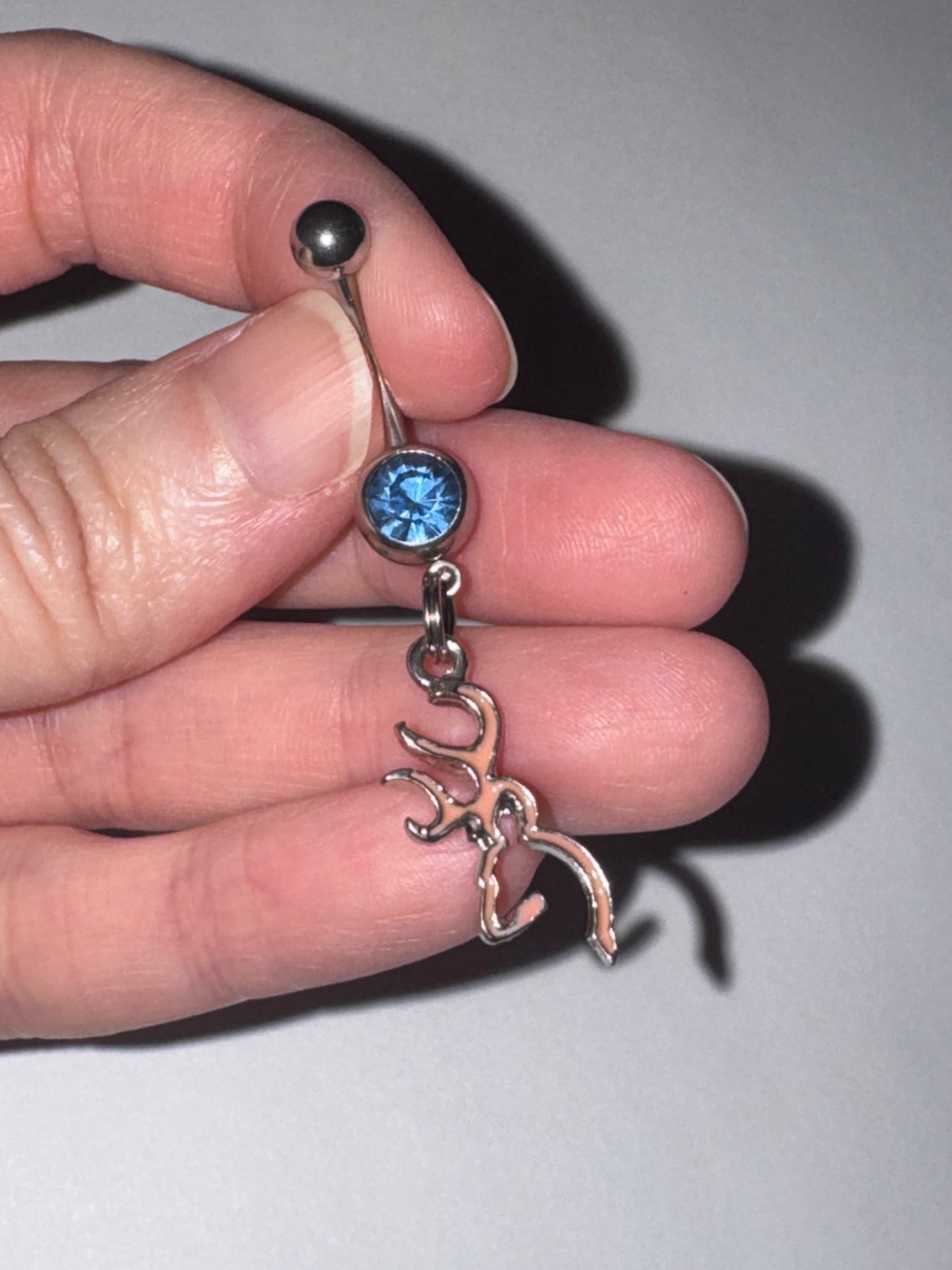 Pink Browning Dangle Belly Ring with a Blue Gem