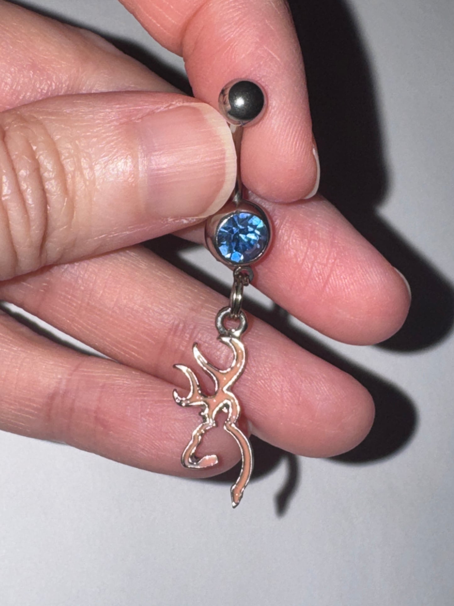 Pink Browning Dangle Belly Ring with a Blue Gem